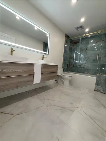 an empty room with closet and windows