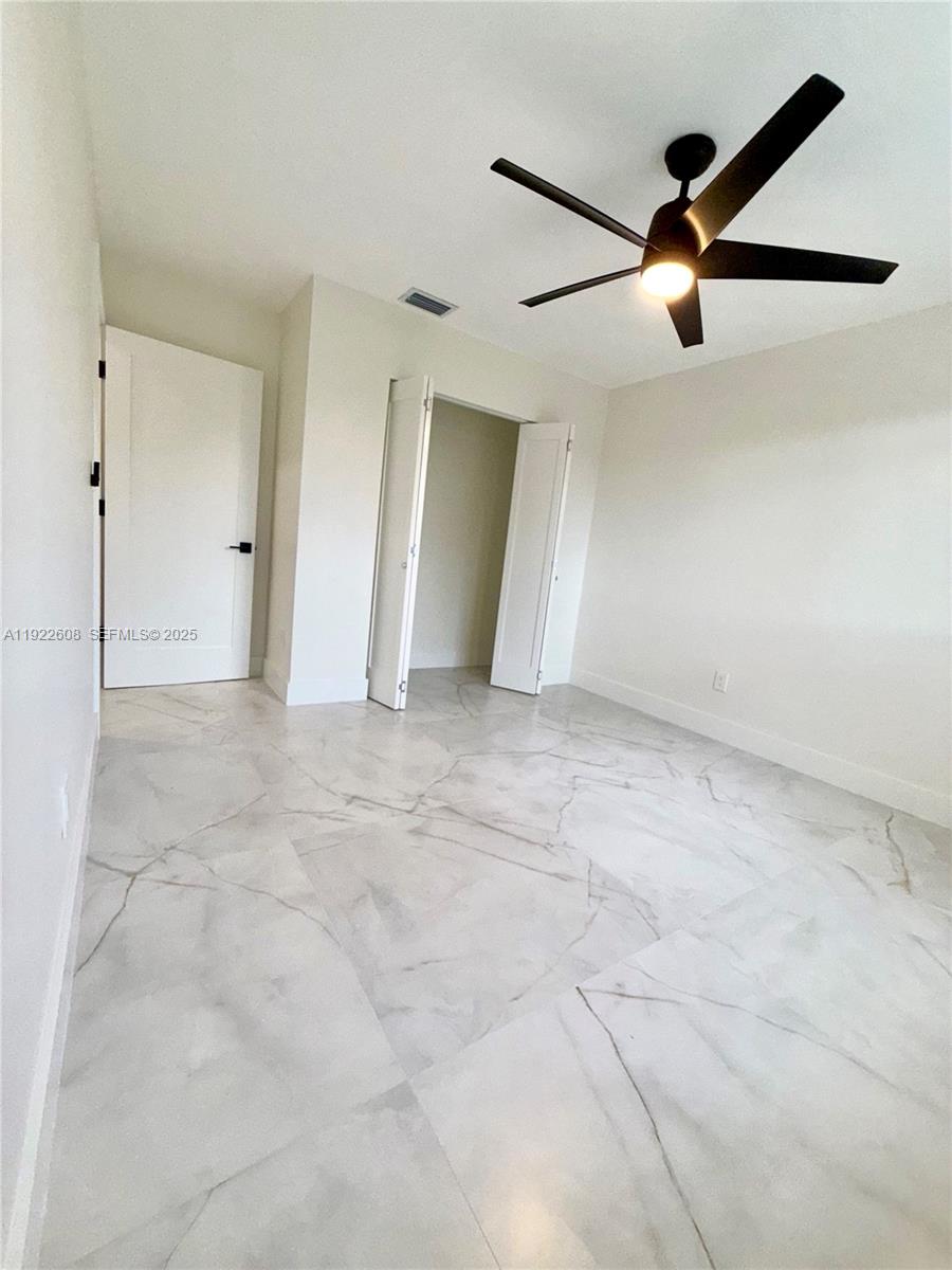 15254 Southwest 109th Street Miami, FL 33196 - Photo 37 of 48 an empty room with closet and windows