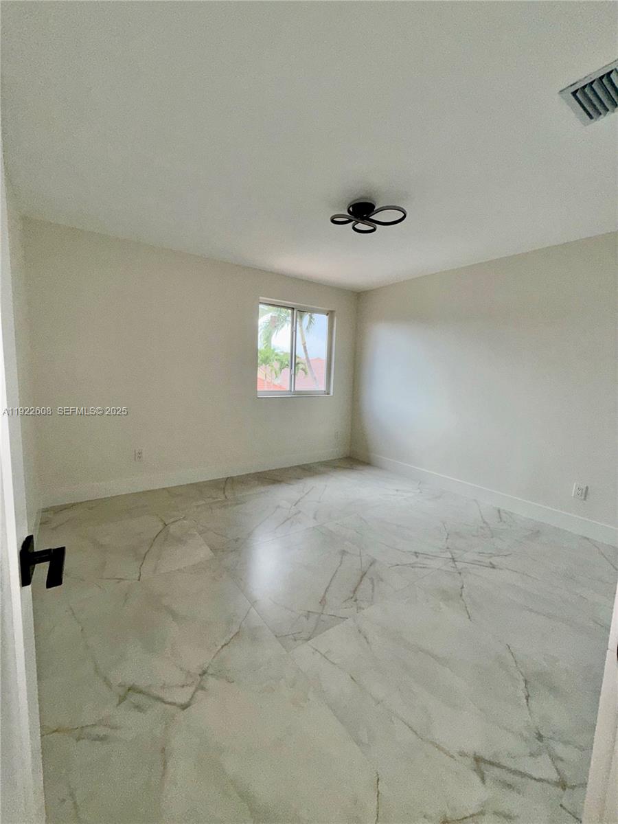 15254 Southwest 109th Street Miami, FL 33196 - Photo 38 of 48 an empty room with windows and closet