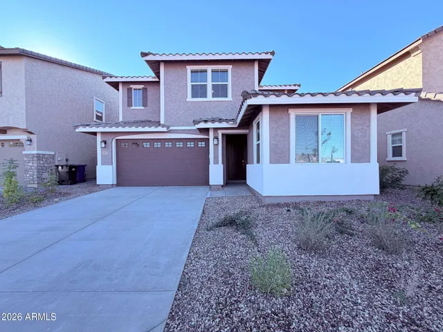 a view of a house with a yard and garage