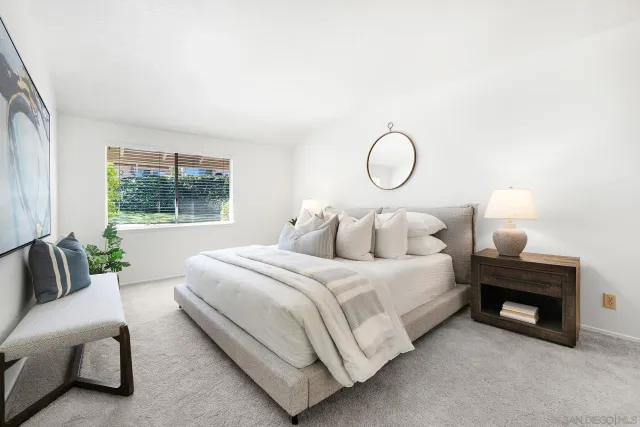 a bedroom with bed and window