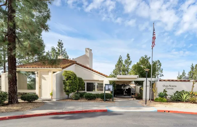 a front view of house with yard and trees around