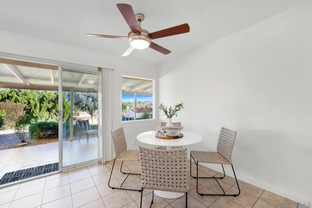 a kitchen with a table chairs a sink and cabinets