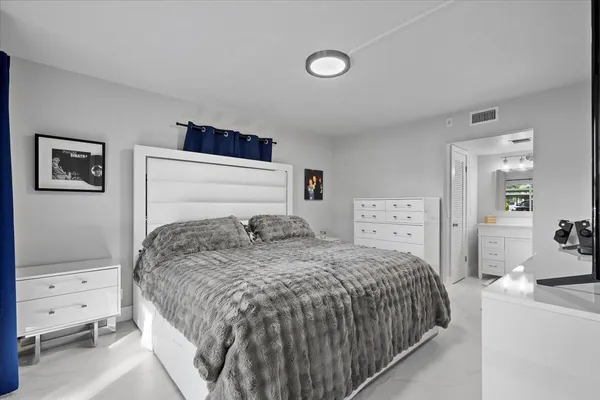 a bedroom with a bed and a cabinets