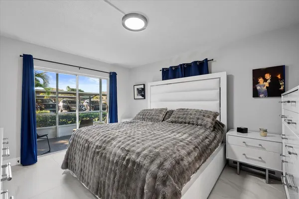 a bedroom with a bed and a flat tv screen