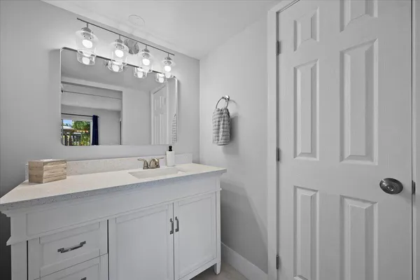 a bathroom with a double vanity sink and a mirror