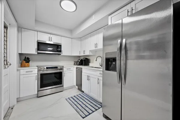 a kitchen with a refrigerator stove and microwave