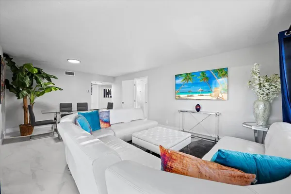 a living room with furniture and a potted plant