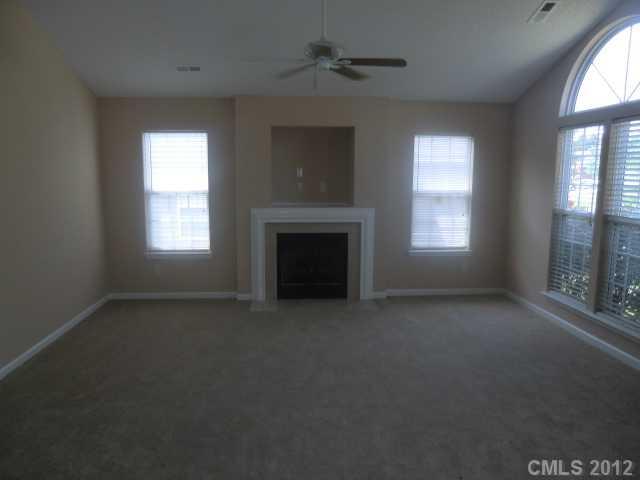 9033 Foggy Meadow Road Charlotte, NC 28269 - Photo 2 of 9 a view of empty room with a fireplace