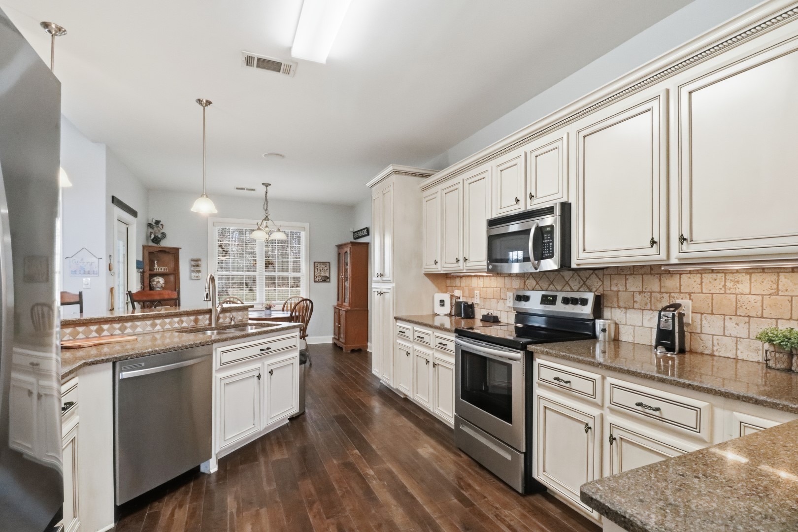 3287 Bluebird Road Lebanon, TN 37087 - Photo 28 of 59 a kitchen with stainless steel appliances granite countertop white cabinets a sink a stove a oven and a refrigerator