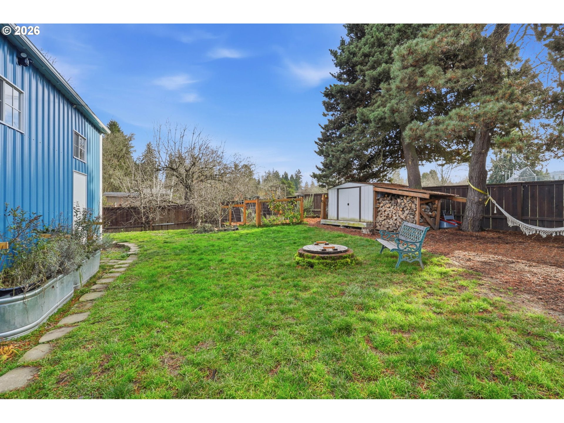 19350 Southwest Murphy Street Beaverton, OR 97078 - Photo 34 of 45 a view of a backyard with table and chairs and wooden fence