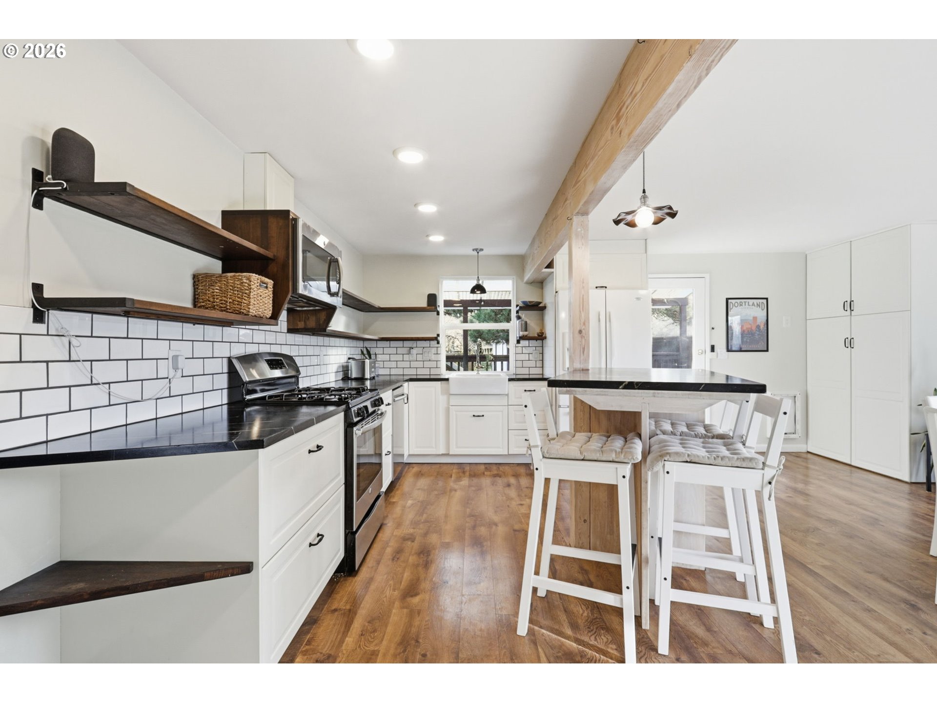 19350 Southwest Murphy Street Beaverton, OR 97078 - Photo 5 of 45 a kitchen with stainless steel appliances kitchen island granite countertop a stove a sink and a refrigerator