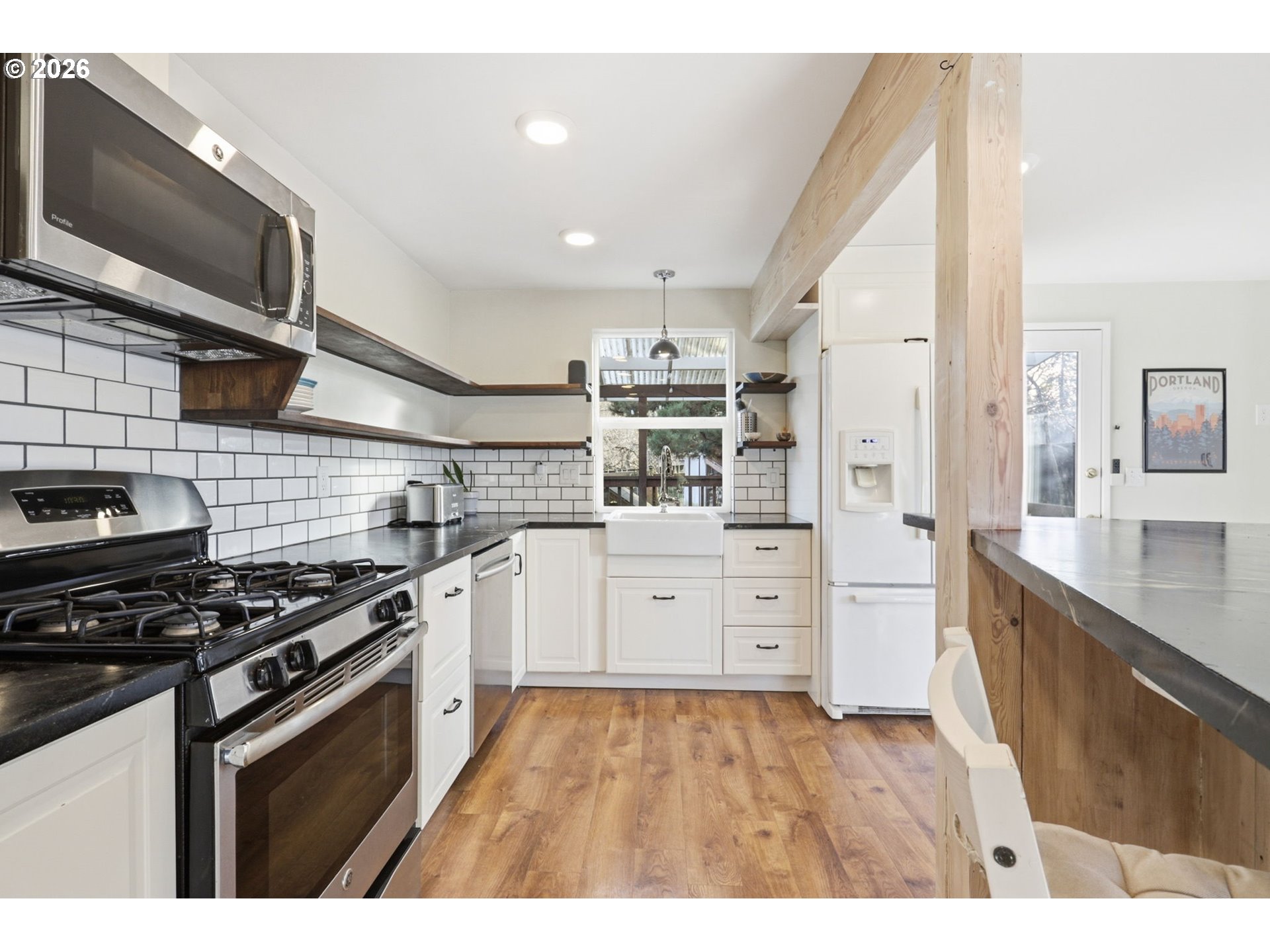 19350 Southwest Murphy Street Beaverton, OR 97078 - Photo 7 of 45 a kitchen with stainless steel appliances a stove sink and cabinets