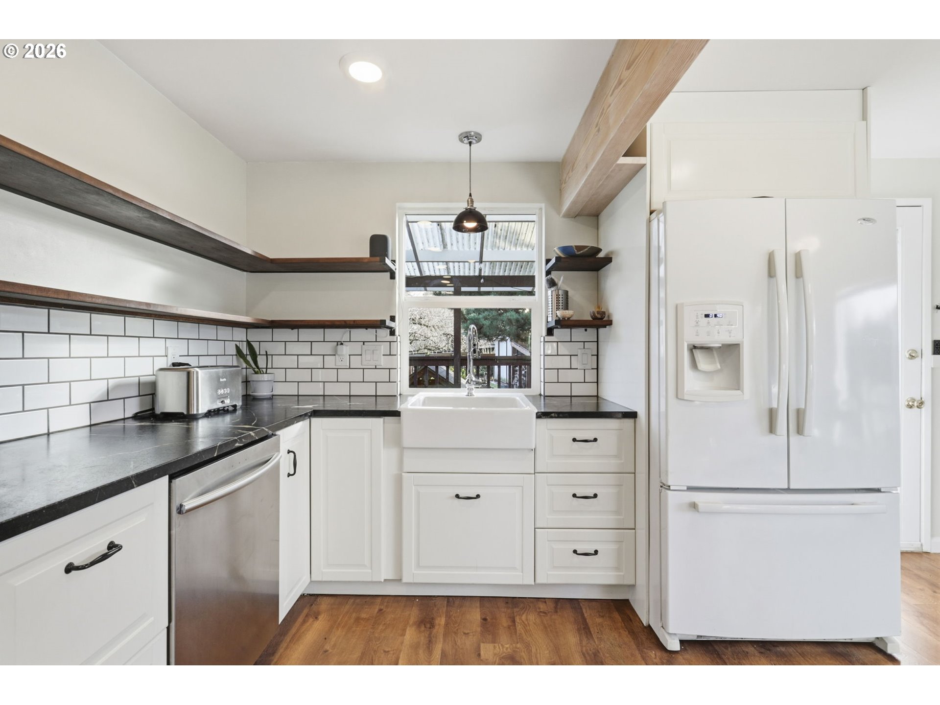 19350 Southwest Murphy Street Beaverton, OR 97078 - Photo 8 of 45 a kitchen with stainless steel appliances kitchen island granite countertop a refrigerator and white cabinets