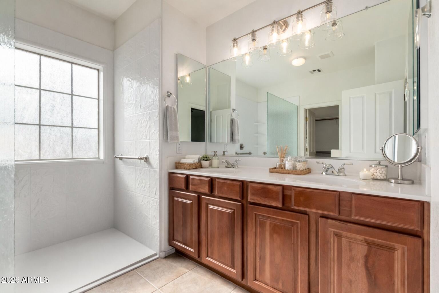 2602 South Nielson Street Gilbert, AZ 85295 - Photo 18 of 39 a bathroom with a double vanity sink a mirror and a shower