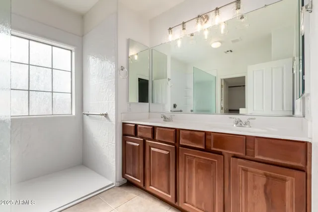 a bathroom with a shower sink and mirror
