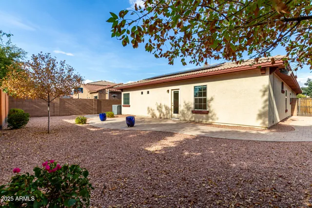 a view of a house with a backyard and garden