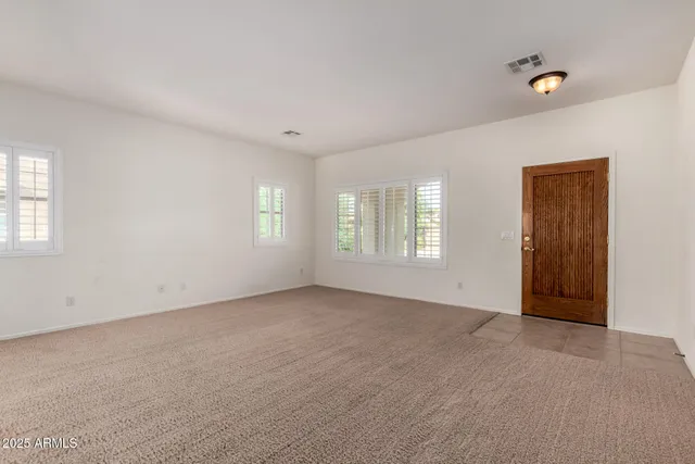 a view of an empty room with windows