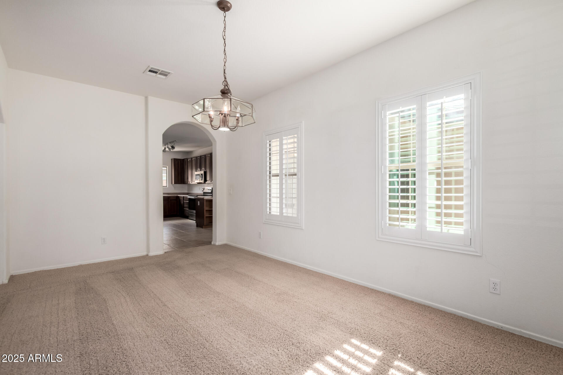 2602 South Nielson Street Gilbert, AZ 85295 - Photo 8 of 39 a view of a room with windows and chandelier