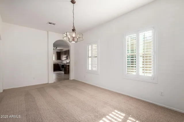 a view of a room with windows and chandelier