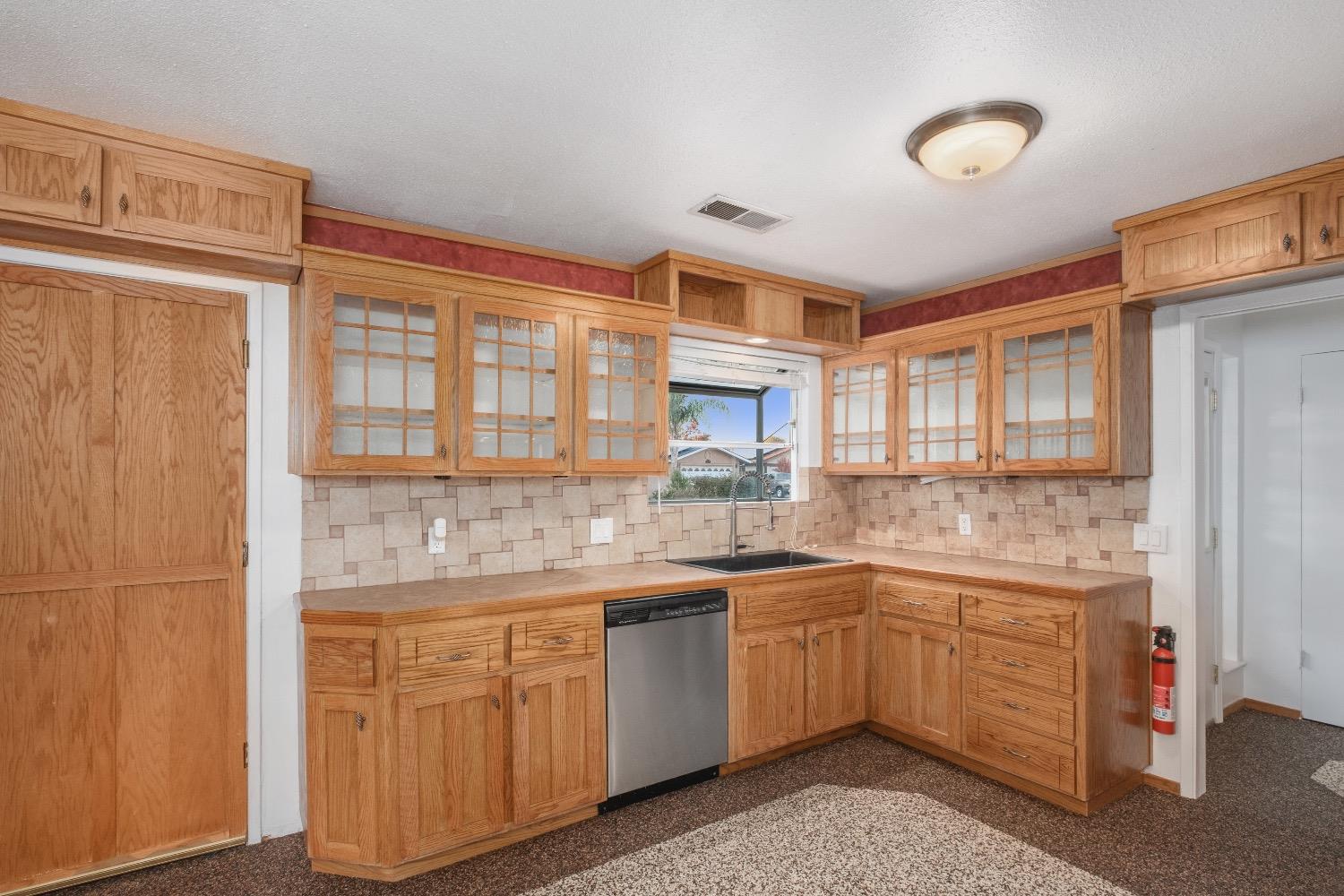 915 Fordham Avenue Clovis, CA 93611 - Photo 11 of 23 a kitchen with a sink stove and cabinets