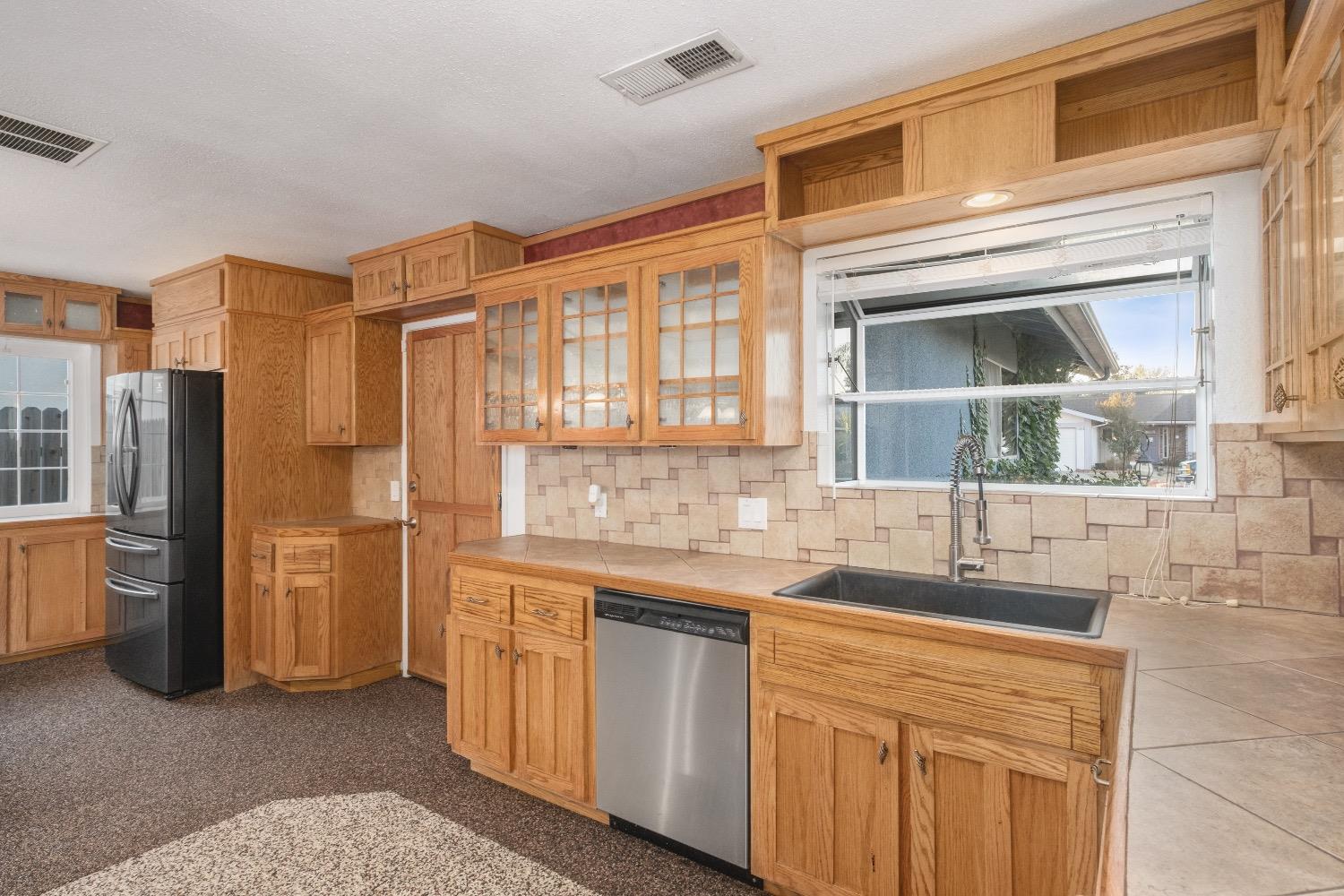 915 Fordham Avenue Clovis, CA 93611 - Photo 12 of 23 a bathroom with a granite countertop sink and a shower