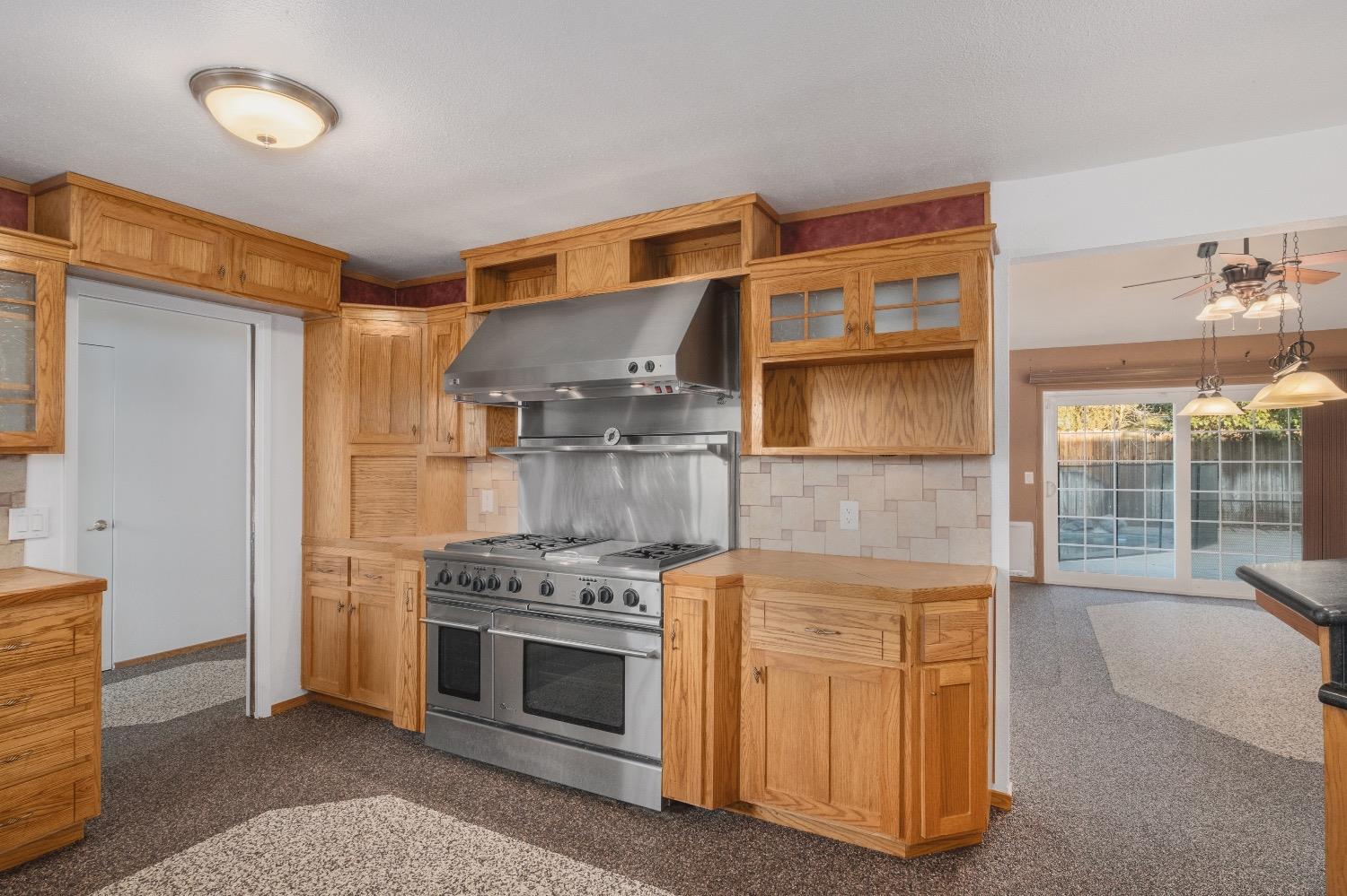 915 Fordham Avenue Clovis, CA 93611 - Photo 13 of 23 a kitchen with stainless steel appliances granite countertop a stove and a refrigerator