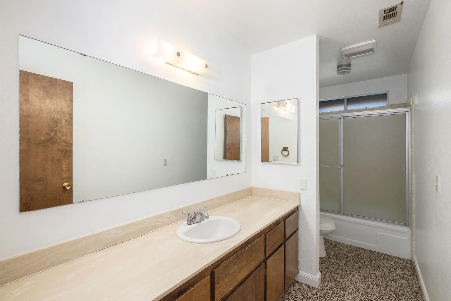 915 Fordham Avenue Clovis, CA 93611 - Photo 18 of 23 a bathroom with a sink and a mirror