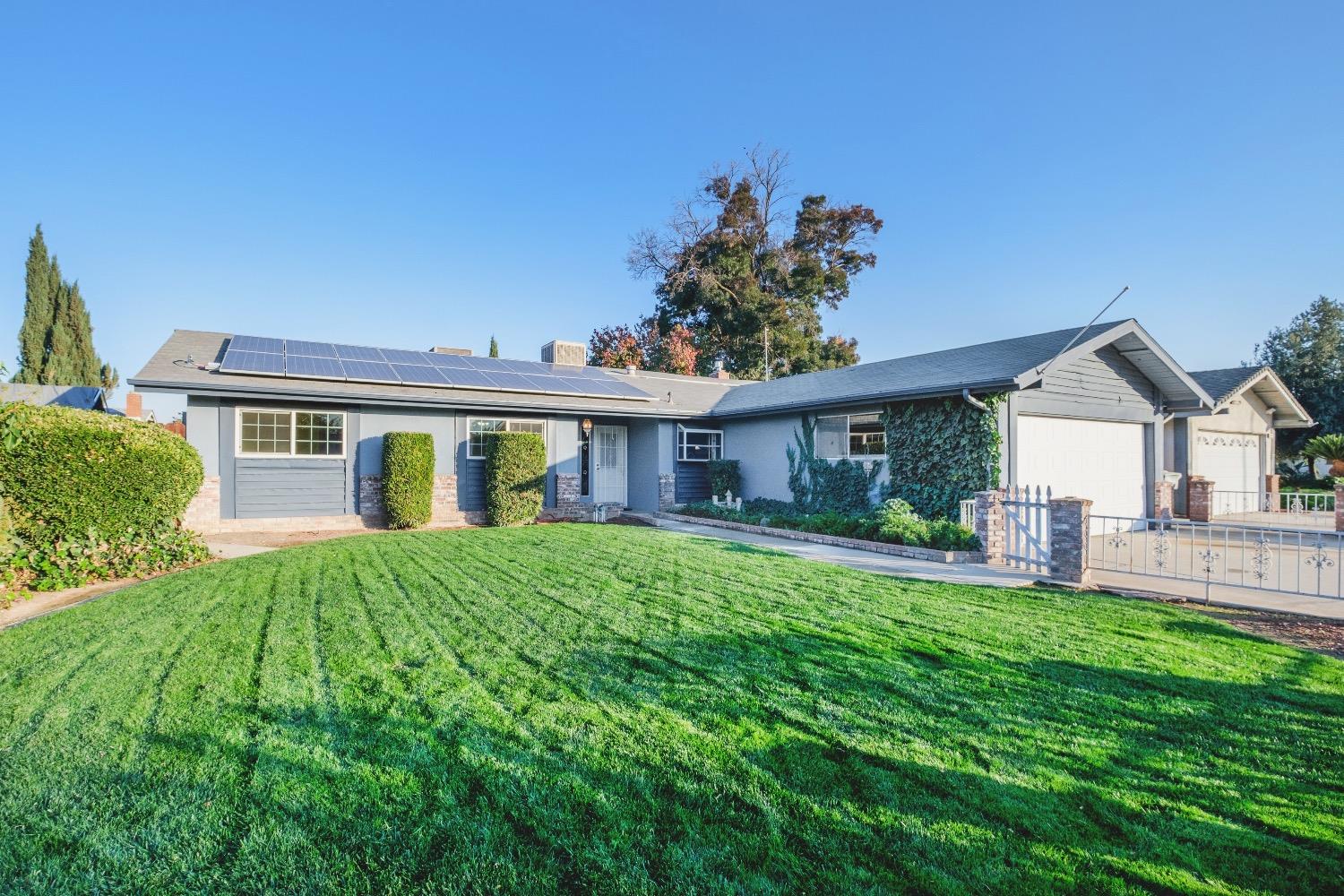 915 Fordham Avenue Clovis, CA 93611 - Photo 2 of 23 a front view of a house with a yard and porch
