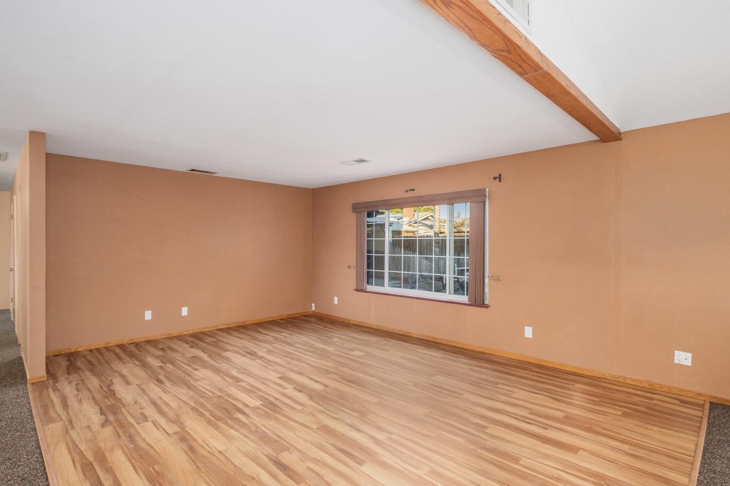 915 Fordham Avenue Clovis, CA 93611 - Photo 5 of 23 a view of an empty room with wooden floor and a window