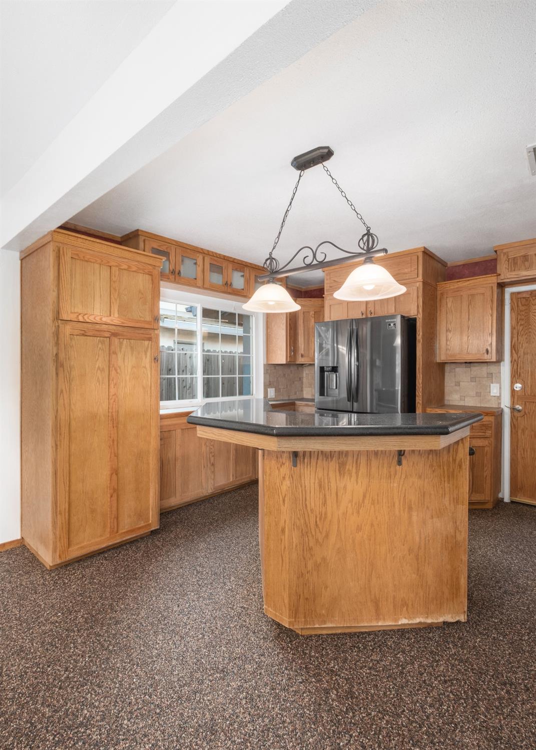 915 Fordham Avenue Clovis, CA 93611 - Photo 9 of 23 a view of a room with a large window and chandelier