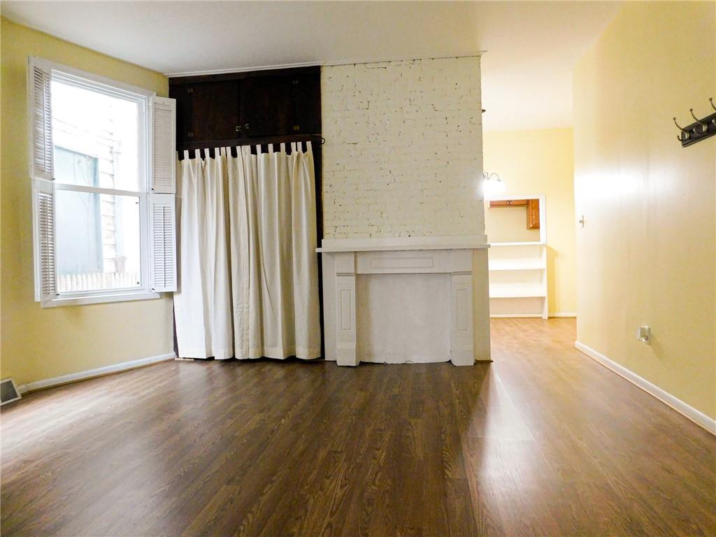 238 Lehigh Avenue Pittsburgh, PA 15232 - Photo 4 of 11 a view of an empty room with wooden floor and a window