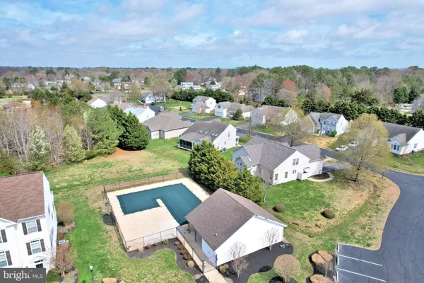 an aerial view of a house with garden space and mountain view in back