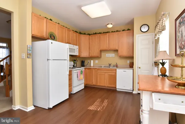 a kitchen with a refrigerator a sink and cabinets