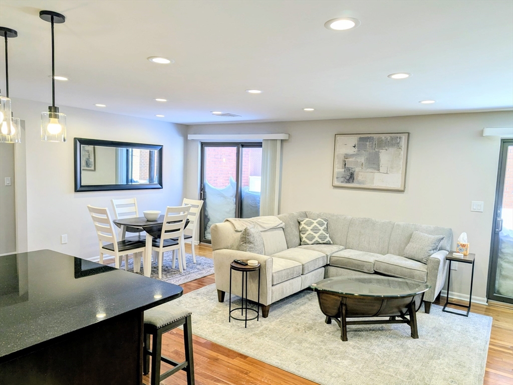 20 Central Street, Unit 405 Salem, MA 01970 - Photo 3 of 18 a living room with furniture a rug and a table