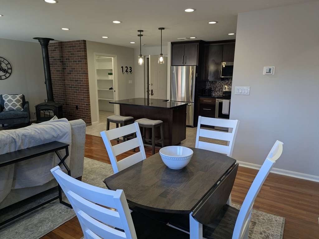20 Central Street, Unit 405 Salem, MA 01970 - Photo 5 of 18 a view of a dining room with furniture and wooden floor
