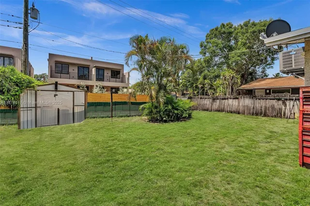 a living room with furniture gym equipment and a kitchen view