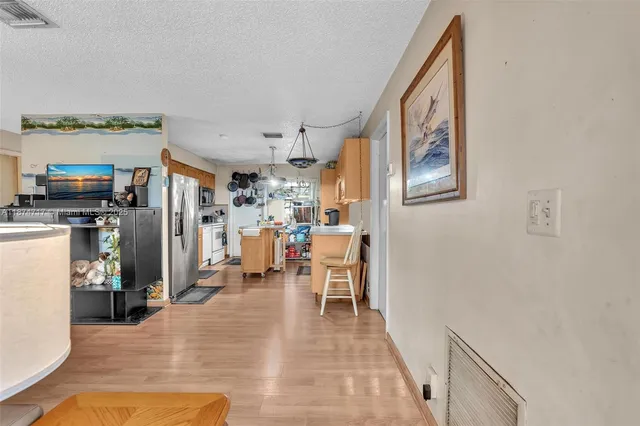a living room with furniture and a dining table
