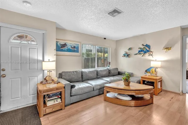 a kitchen with white cabinets and sink