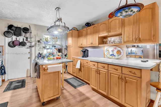 a kitchen with stainless steel appliances granite countertop a refrigerator a stove and a sink with dishwasher