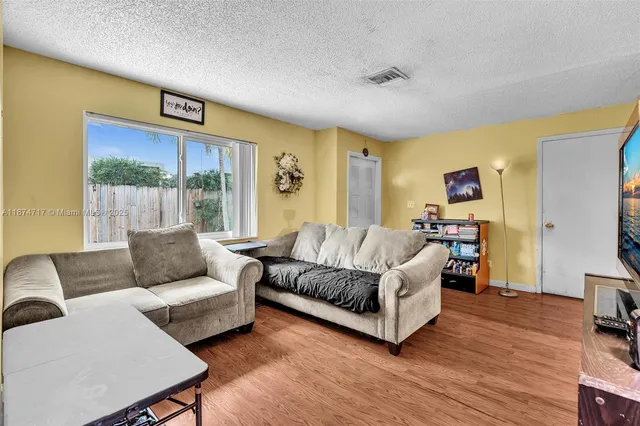 a kitchen with a refrigerator and a stove top oven
