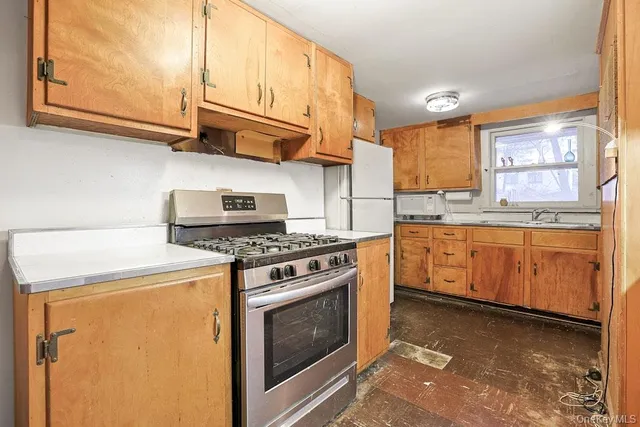 a kitchen with stainless steel appliances granite countertop a refrigerator and a stove