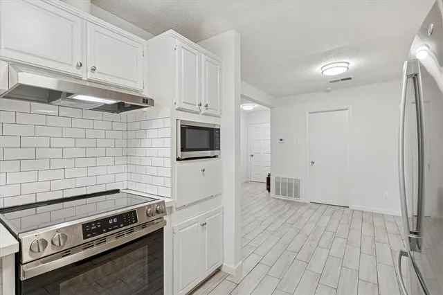 a kitchen with a stove and a microwave