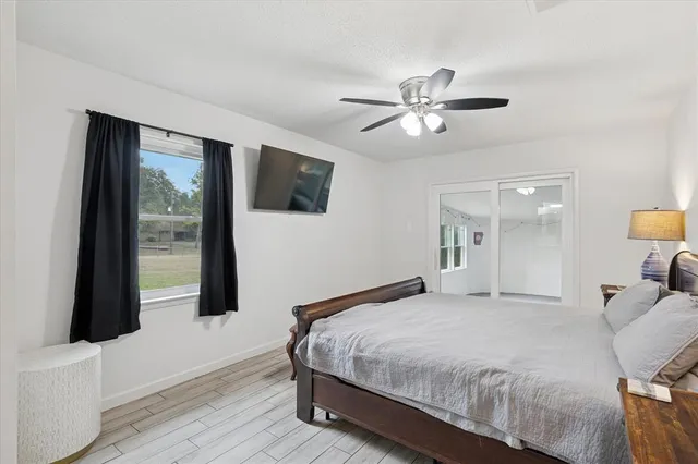 a bedroom with a large bed and a flat tv screen