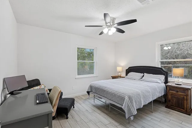 a bedroom with a bed and wooden floor