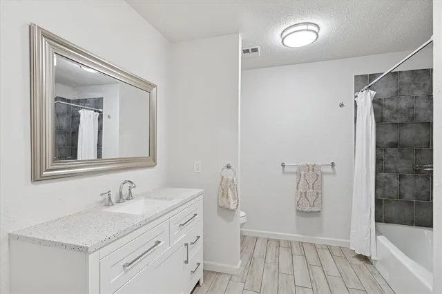 a bathroom with a sink a mirror and a bathtub