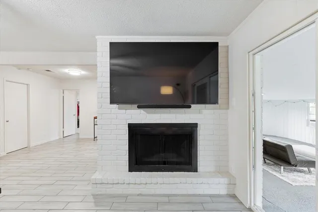 a living room with a fireplace and a flat screen tv