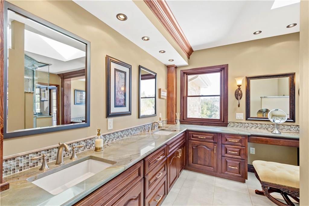 104 Gatehouse Drive Coraopolis, PA 15108 - Photo 17 of 24 a spacious bathroom with a granite countertop double vanity sink a mirror and a bathtub
