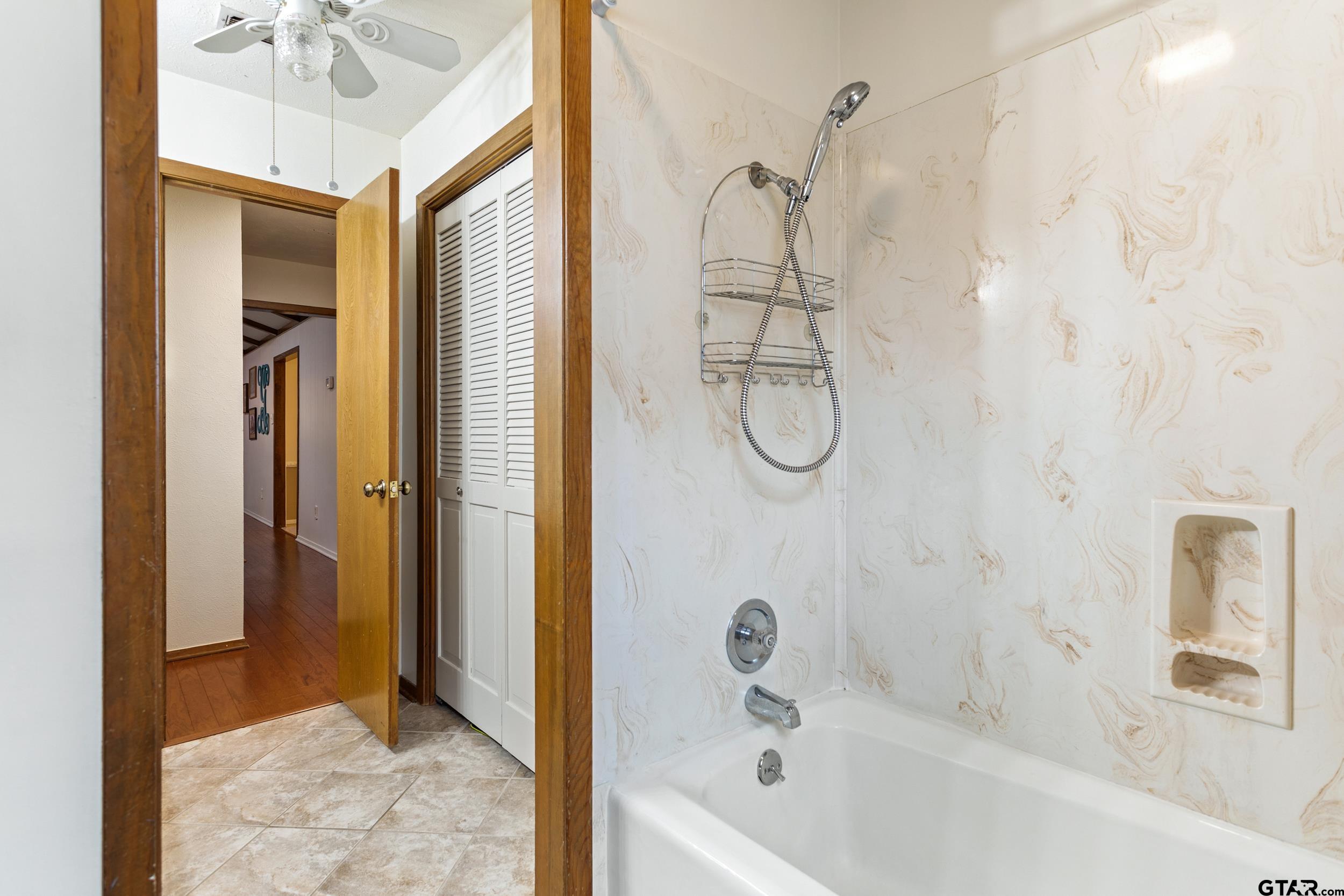 516 Ruthlynn Drive Longview, TX 75605 - Photo 25 of 34 a bathroom with a bath tub shower and a sink