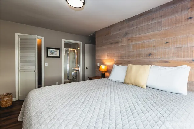 a bedroom with a bed and a lamp